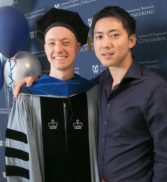 Graduating PhD Student posing with another individual
