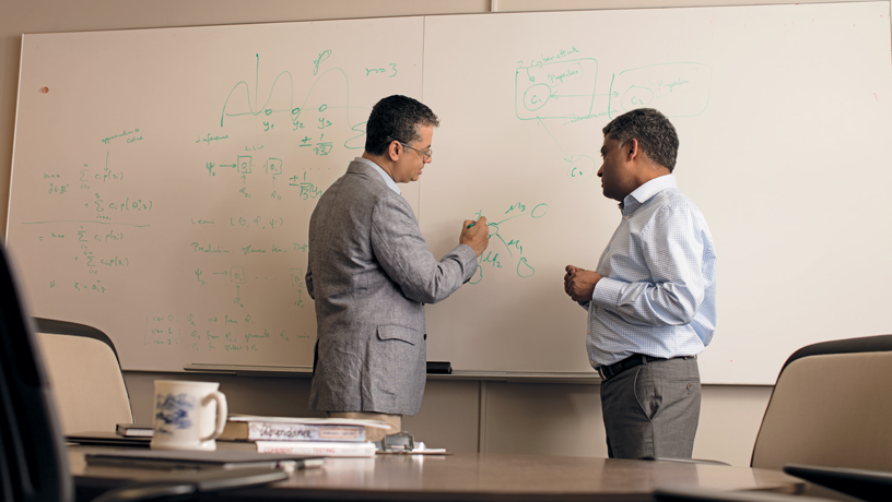 Interdisciplinary research pioneered by Garud Iyengar (right) and Vishal Misra (left) makes it possible to model the probability of intrusions. Their work makes use of machine learning to identify industry-wide vulnerabilities. (Photo by Jeffrey Schifman) Interdisciplinary research pioneered by Garud Iyengar (right) and Vishal Misra (left) makes it possible to model the probability of intrusions. Their work makes use of machine learning to identify industry-wide vulnerabilities. (Photo by Jeffrey Schifman)