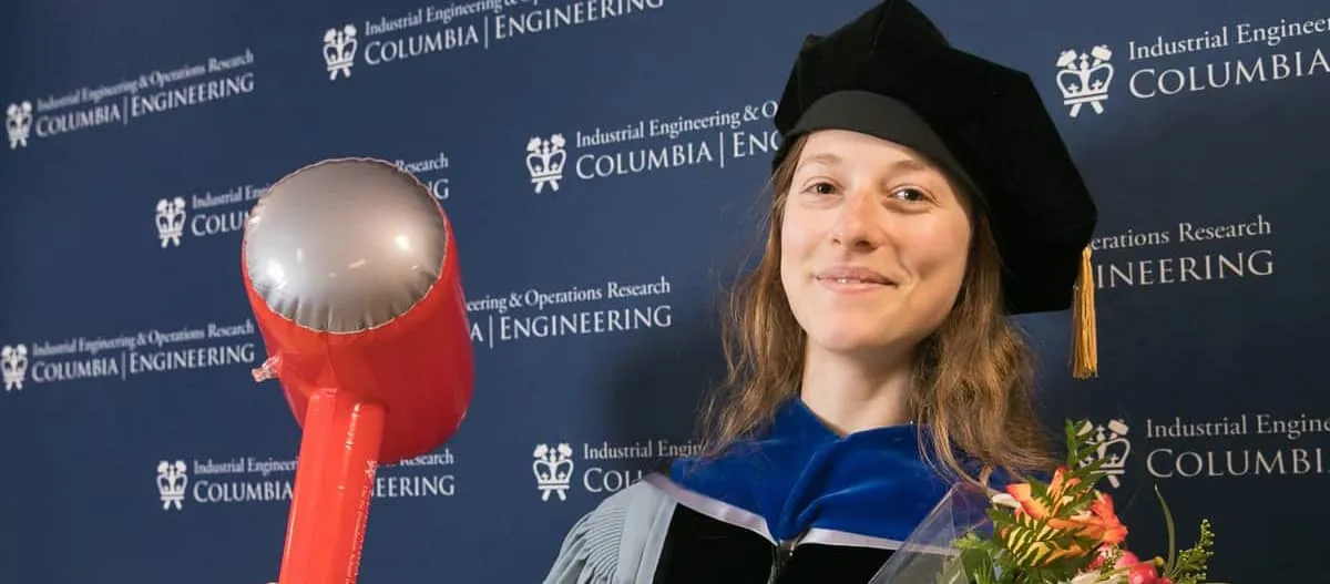 PhD Student in cap and gown