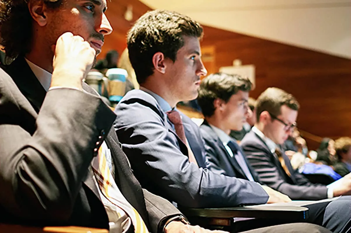 Row of young people sitting in classroom