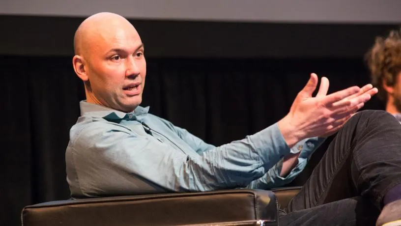 Computer Science Professor Tim Roughgarden fielding an audience member's question on automated auction reserve pricing.