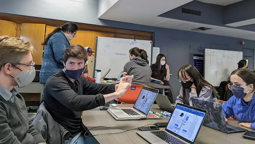 Students in the Designing for Humanity class work collaboratively to solve problems